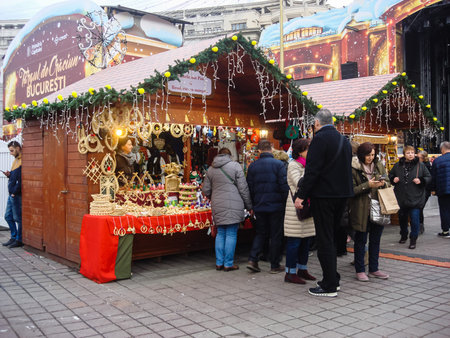 Decorated huge Christmas tree, lights, decorations, hot wine, hot chocolate, presents and people wandering at the Christmas market in Bucharest, Romania, 2019のeditorial素材