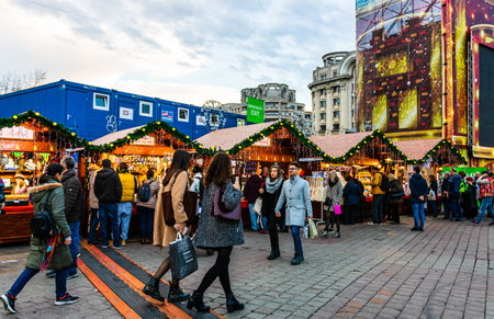 Bucharest Christmas market in front of the Palace of Parliament, Christmas tree, lights, people wandering at the Christmas market in Bucharest, Romania, 2019のeditorial素材
