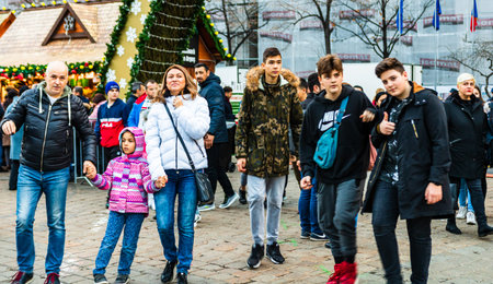 Bucharest Christmas market in front of the Palace of Parliament, Christmas tree, lights, people wandering at the Christmas market in Bucharest, Romania, 2019のeditorial素材