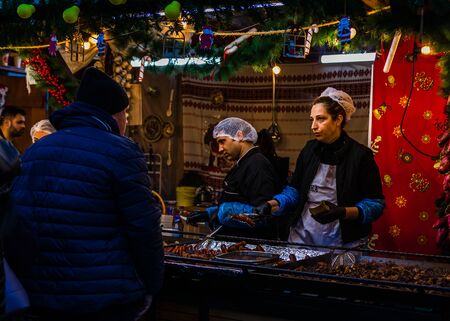 Bucharest Christmas market in front of the Palace of Parliament, lights, decorations, hot wine, hot chocolate, presents and people wandering at the Christmas market in Bucharest, Romania, 2019のeditorial素材