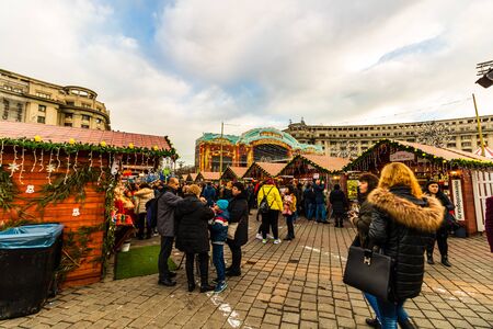 Bucharest Christmas market in front of the Palace of Parliament, Christmas tree, lights, people wandering at the Christmas market in Bucharest, Romania, 2019のeditorial素材
