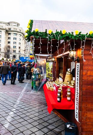 Bucharest Christmas market in front of the Palace of Parliament, lights, decorations, hot wine, hot chocolate, presents and people wandering at the Christmas market in Bucharest, Romania, 2019のeditorial素材