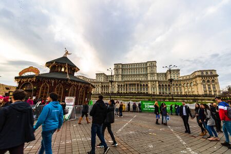Bucharest Christmas market in front of the Palace of Parliament, Christmas tree, lights, people wandering at the Christmas market in Bucharest, Romania, 2019のeditorial素材