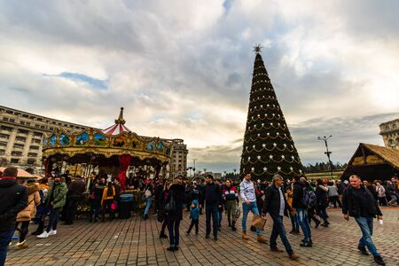 Bucharest Christmas market in front of the Palace of Parliament, Christmas tree, lights, people wandering at the Christmas market in Bucharest, Romania, 2019のeditorial素材