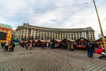 Bucharest Christmas market in front of the Palace of Parliament, Christmas tree, lights, people wandering at the Christmas market in Bucharest, Romania, 2019のeditorial素材