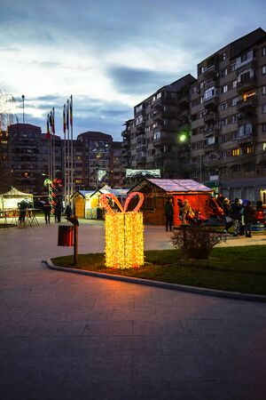 Christmas tree and lights in winter holiday market of Targoviste. People celebrating Christmas outdoor in the town square of Targoviste, Romania, 2019のeditorial素材