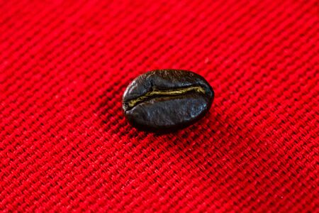 Roasted coffee beans on red background, top view, copy space for text, coffee conceptの写真素材