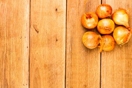 Detail view of onions on wooden background, top view, copy space for text, close up photoの写真素材