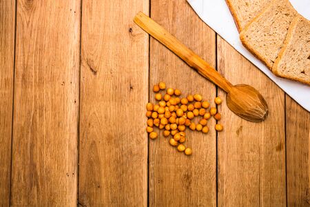 Wholegrain toast on white napkin and croutons for lunch over wooden table, top view, copy space, lunch conceptの写真素材
