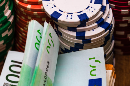 Poker casino chips and money close up. Casino concept, risk, chance, good luck or gambling. Detail...