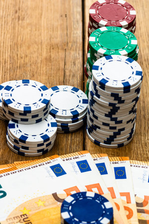 Poker casino chips and money close up. Casino concept, risk, chance, good luck or gambling. Detail...