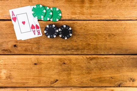 Stacks of poker chips and Ace and King on wooden background, poker chips spread, dealer, gambler, poker conceptの写真素材