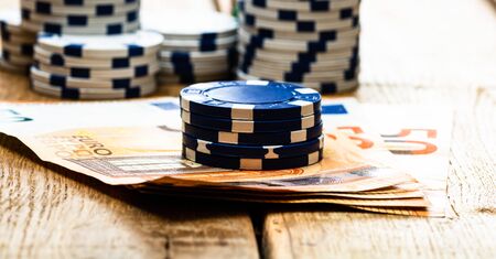 Poker casino chips and money close up. Casino concept, risk, chance, good luck or gambling. Detail of casino chips, EURO, US dollarsの写真素材