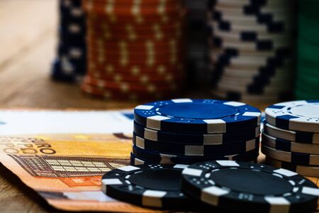 Poker casino chips and money close up. Casino concept, risk, chance, good luck or gambling. Detail of casino chips, EURO, US dollarsの写真素材