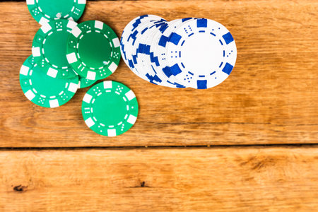Stacks of poker chips on wooden table, poker chips spread. Casino concept for business, risk,...
