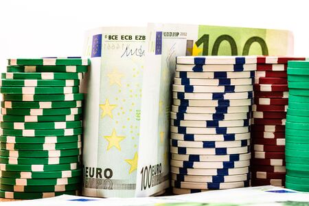 Poker casino chips and money close up. Casino concept, risk, chance, good luck or gambling. Detail of casino chips, EURO, US dollarsの写真素材