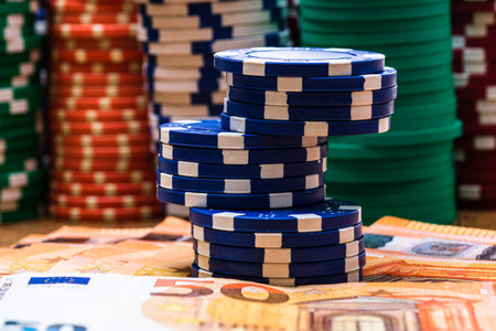 Poker casino chips and money close up. Casino concept, risk, chance, good luck or gambling. Detail...