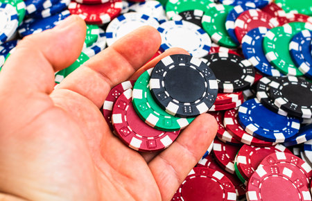 Hand holding and giving poker chips poker chips background. Casino concept for business, risk,...