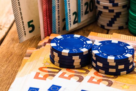 Poker casino chips and money close up. Casino concept, risk, chance, good luck or gambling. Detail of casino chips, EURO, US dollarsの写真素材