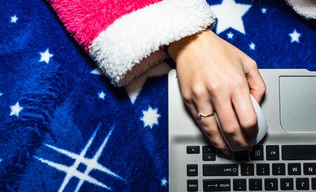 Detail of woman hand using a white mouse over a laptop keyboard. Business concept, close upの写真素材