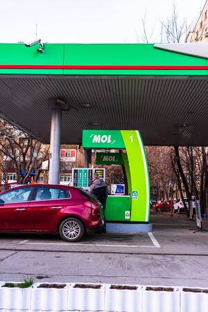 People filling their car tanks at MOL petrol gasoline station in Bucharest, Romania, 2020のeditorial素材