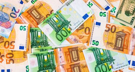 World money concept, detail on EURO and US dollar banknotes, EURO and US currency background, inflation, finance and business conceptの写真素材