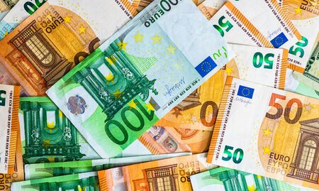 World money concept, detail on EURO and US dollar banknotes, EURO and US currency background, inflation, finance and business conceptの写真素材