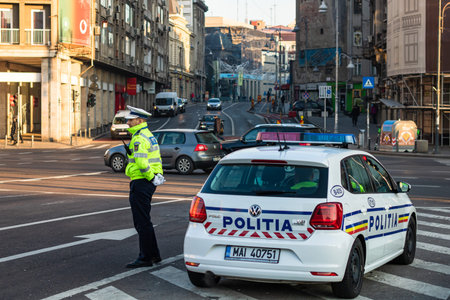 Local police man, Romanian police man, traffic police man (Politia Rutiera) directing traffic in...