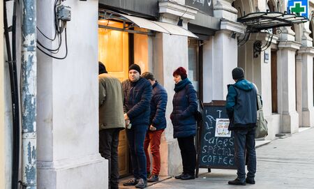 People waiting in line to buy pretzels in the morning. Winter scene in Bucharest, Romania, 2020のeditorial素材