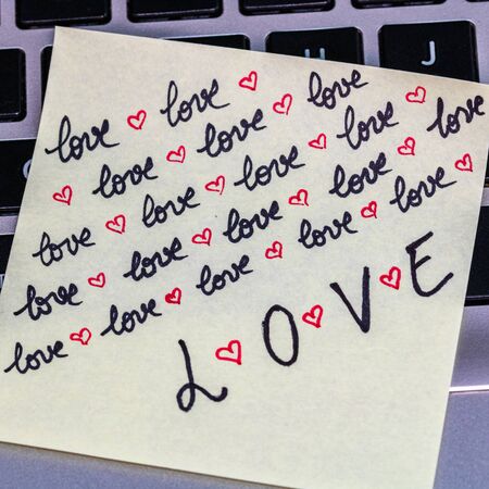 Writing love text on memo post reminder. Sticker with lovely message. Text on notepaper.の写真素材