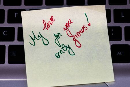 Writing love text on memo post reminder. Sticker with lovely message. Text on notepaper.の写真素材