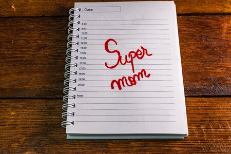 Mother`s day concept. Writing text for mother on personal agenda. Super mom.の写真素材