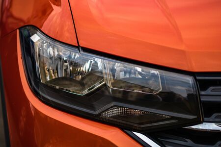 Close up photo of modern and clean car, detail of headlight. Headlight car Projector/LED of a modern luxury technology and auto detail.の写真素材