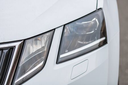 Close up photo of modern and clean car, detail of headlight. Headlight car Projector/LED of a modern luxury technology and auto detail.の写真素材