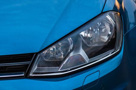 Close up photo of modern and clean car, detail of headlight. Headlight car Projector/LED of a modern luxury technology and auto detail.の写真素材