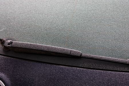 First thin layer of snow on cars in the morning. Winter season, icy cars. Winter concept, frozen cars on the road in Bucharest, Romania, 2020の写真素材