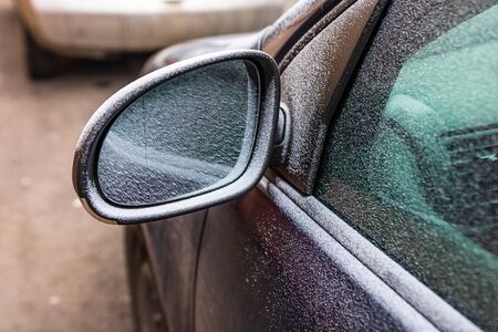 First thin layer of snow on cars in the morning. Winter season, icy cars. Winter concept, frozen cars on the road in Bucharest, Romania, 2020の写真素材