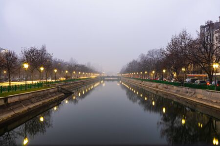 Long exposure photo of Dambovita river and the evening traffic on the main boulevard in downtown Bucharest, Romania, 2020のeditorial素材