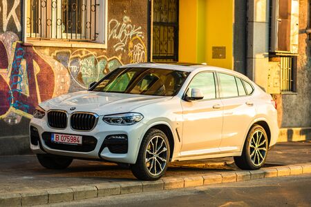 The new BMW X6 car parked on the sidewalk, early morning sunlight in Bucharest, Romania, 2020のeditorial素材