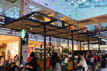 People sitting, waiting in line and working at the Starbucks at AFI Cotroceni Mall from Bucharest, Romania, 2020のeditorial素材