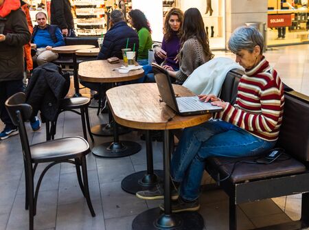 People sitting, waiting in line and working at the Starbucks at AFI Cotroceni Mall from Bucharest, Romania, 2020のeditorial素材
