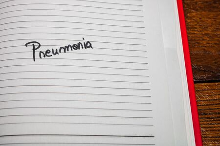 Pneumonia, handwriting text on page of office agenda. Copy space.の写真素材