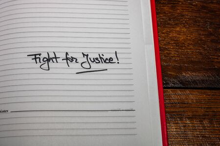 Fight for justice, handwriting text on page of office agenda. Copy space.の写真素材