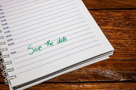 Save the date, handwriting text on page of office agenda. Copy space.の写真素材