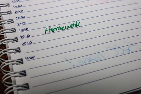 Homework, handwriting text on page of office agenda. Copy space.の写真素材