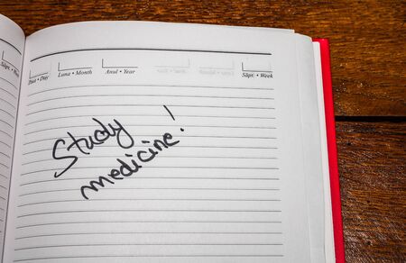 Study medicine, handwriting text on page of office agenda. Copy space.の写真素材