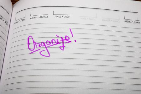 Organize, handwriting text on page of office agenda. Copy space.の写真素材