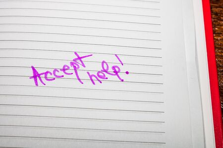 Accept help, handwriting text on page of office agenda. Copy space.の写真素材