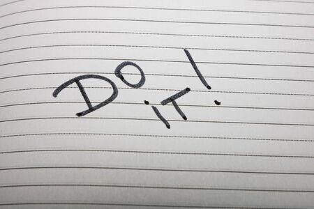 Do it, handwriting text on page of office agenda. Copy space.の写真素材