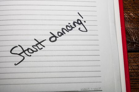 Start dancing, handwriting text on page of office agenda. Copy space.の写真素材